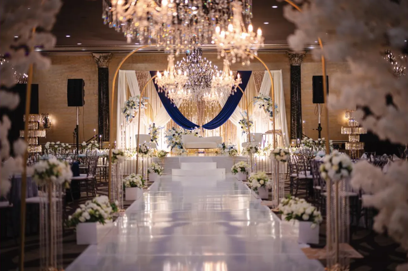 Sapphire and gold aisle lined with candelabras and florals
