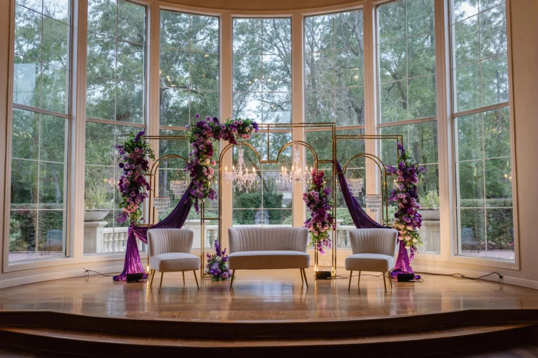Violet and gold mandap in a conservatory